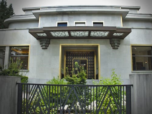 Front view of the villa with entrance and fence as seen from the street